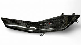 Carbon fiber exhaust guard for Husqvarna 701 motorcycle, featuring a sleek black design with a Wolfcarbon logo.