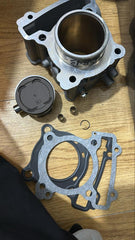 Mechanical parts including a gasket and metal components on a wooden surface