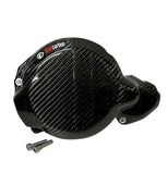 Carbon fiber ignition guard with the Wolfcarbon logo, intended for use on motorcycles, displayed alongside screws for installation.